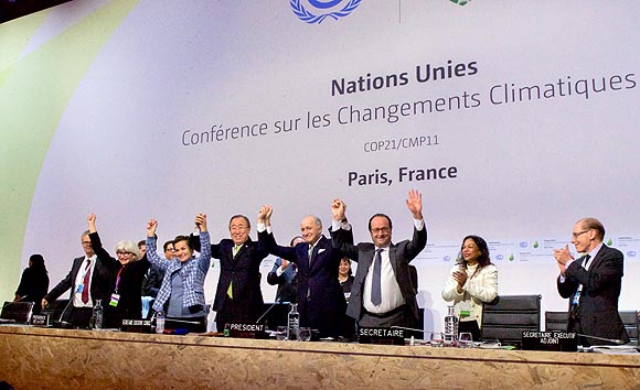 French_Foreign_Minister,_UN_Secretary-General_Ban,_and_French_President_Hollande_Raise_Their_Hands_After_Representatives_of_196_Countries_Approved_a_Sweeping_Environmental_Agreement_at_COP21_in_Paris_(23076185424).jpg