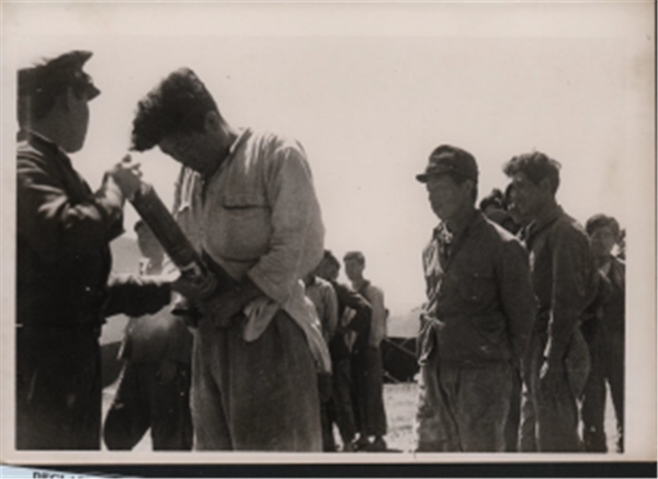 1948년 6월 수용자들에게 미군정에 의해 지급된 소독약(DDT)을 뿌리고 있다. 사진=제주4.3평화재단.<br>