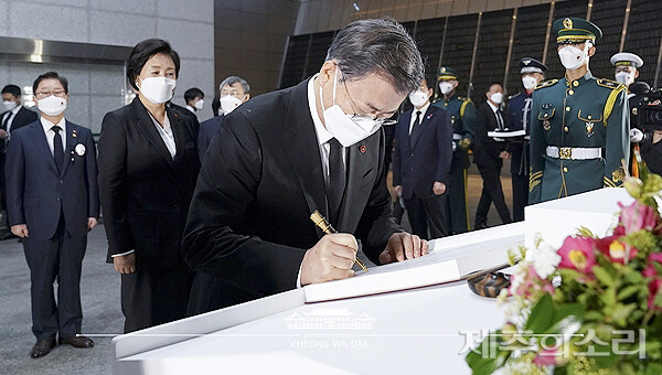 문재인 전 대통령이 2021년 제73주년 4.3희생자추념식에 참석해 헌화·분향 직후 위패봉안관으로 이동, 4.3특별법 전부개정을 기념하는 법령집에 서명하는 모습.